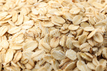 Oatmeal flakes texture on whole background, close up