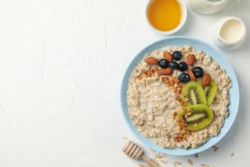 Composition with oatmeal with fruits on white background
