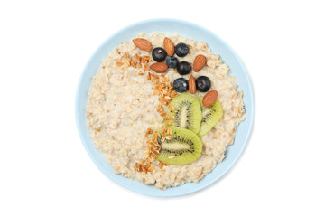 Bowl with oatmeal porridge and ingredients isolated on white background