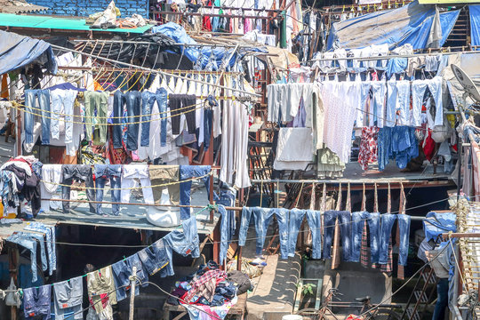 MUMBAI, INDIA - February 29 2020: Clothes jeans mostly from the hospital and hotel hanging on a clothesline to dry at Dhobi Ghat largest open-air laundry, Mahalaxmi area, Mumbai, India