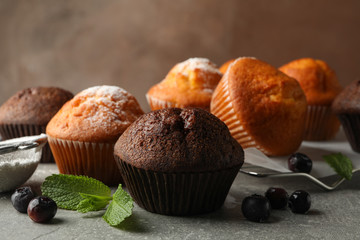 Composition with delicious muffins on gray background
