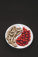 Two types of pills on a black background