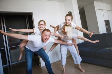 Young family of four having fun at home.