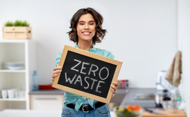 eco living, environment and sustainability concept - portrait of happy smiling young woman in...