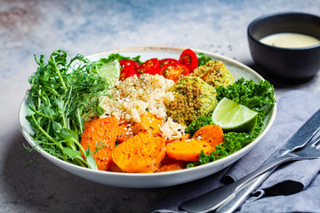 Vegan dinner. Quinoa salad with baked sweet potato, falafel, kale and pea seedlings. Healthy Falafel salad bowl.