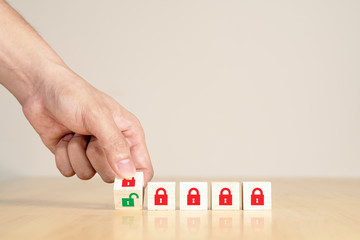 Man's hand turning wooden box red key lock to green unlock key. Start unlock lockdown after coronavirus covid-19 pandemic or epicdemic crisis. Time to repoening, relunch or restart concept