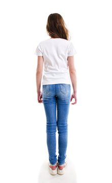 Little girl child preteen in jeans and white t-shirt standing isolated