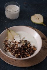 Granola with pear and greek yogurt. Vegetarian breakfast. Healthy eating.
