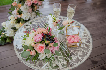 champagne and rings on an arch table for ceremony