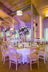 Fototapeta na wymiar wedding tables in a restaurant with decor and flowers