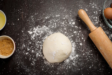 Top view of ingredients bakery making on black wooden table