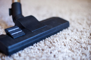 vacuuming a carpet. vacuum cleaner brush on the carpet