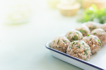 Delicious vegan buckwheat balls on kitchen table with ingredients. Healthy home cooking and eating. Сlose up, blurred background, place for text.