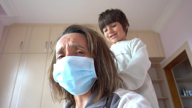 Fethiye, Turkey - 12h of May, 2020: 4K Lockdown meltdown Selfie - Furious mother in mask and child combing her

