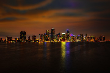 Fototapeta na wymiar Miami downtown view at night. Miami city, Florida skyline panorama at dusk with urban skyscrapers and bridge over sea with reflection. Miami Florida, skyline.