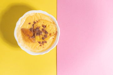 delicious custard in yellow and pink background