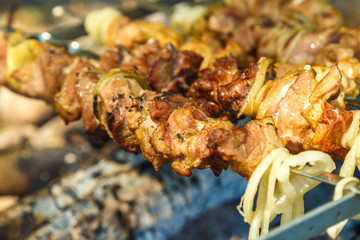 Preparation of shish kebab on outdoor charcoal grill