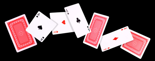 Flying playing cards for poker game on black background.