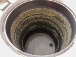 Scale in electric kettle There is a little water in the kettle.
