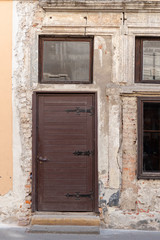 Fototapeta premium Old wooden door close-up on a background of a wall .