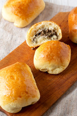 Home-baked Beef Russian Bierocks on a rustic wooden board, low angle view. Close-up.