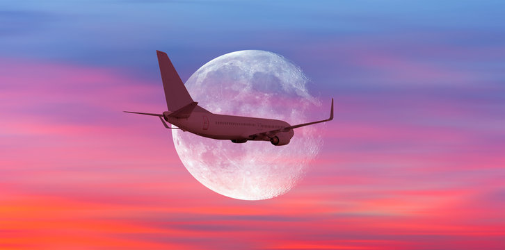 Passenger airplane in the sky against blue full moon "Elements of this image furnished by NASA "