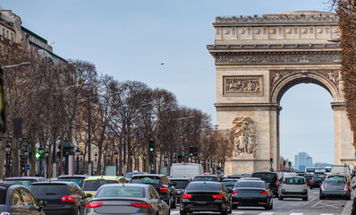Fototapeta na wymiar Arch of Triumph (Arc de triomphe) and Champs Elysees with many cars on traffic - Paris, France