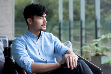 Asian business male resting in the outdoors