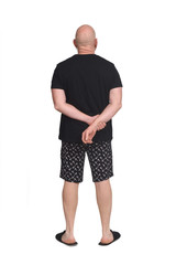Fototapeta premium rear view of bald man in short pajamas on white background,hand crossed