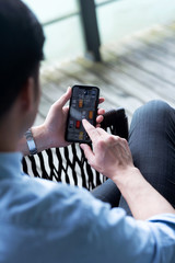 Asian business male using mobile phone in the outdoors