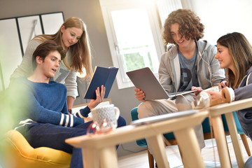 Group of flatmates having fun at home