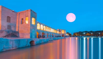 Cercles muraux Pont Khadjou People resting in the ancient Khaju Bridge at twilight blue hour with full moon - Isfahan, Iran "Elements of this image furnished by NASA"