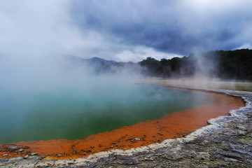 Geothermal lake with an orange shoreline