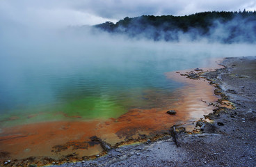 Geothermal lake with an orange shoreline