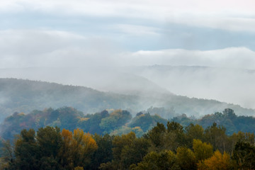 Aerial view of a foggy autumn forest in the morning