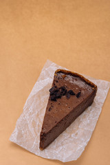 slice of chocolate cheesecake on a gold background