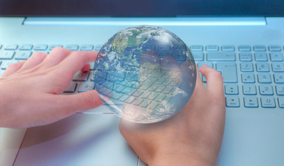 Close up of female blured hands typing on laptop keyboard  "Elements of this image furnished by NASA 