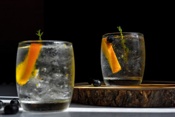 orange slice in glass on black background