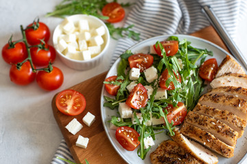 Close-up on a salad with chicken and tomato