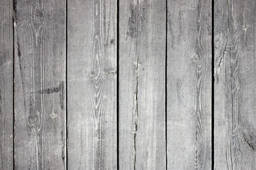 Natural wood, rough texture. Vertical boards on the wall, closeup. Weathered boards on an old house. Real natural wood grungy textures. The natural surface of the wooden cladding olboards on old house