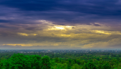 landsacpe view,green forest and city view with dim blue sky with yellow light