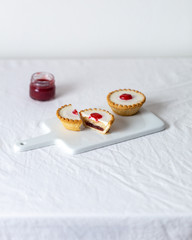 Vegan coconut Raspberry tartlets on white background