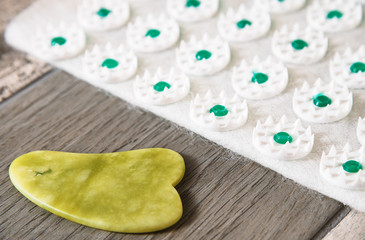 Gua sha tool in natural gemstone of green Jade with Acupressure mat. Alternative medicine and self massage at home massage concept