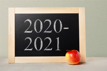 School board with numbers 2020 2021. Background School blackboard and apple. Beginning of the school year.
