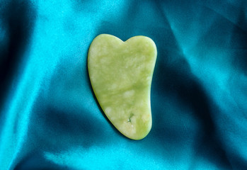 Fototapeta premium gua sha tool in natural gemstones of Green Jade
