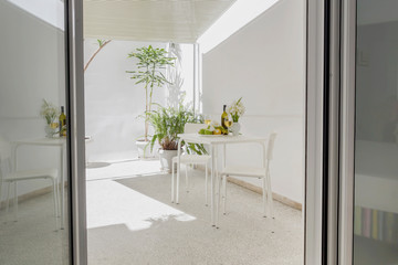 Table with fruit, white irises and wine on the patio close-up