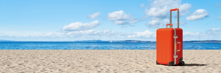 Red suitcase on the beach on vacation in summer