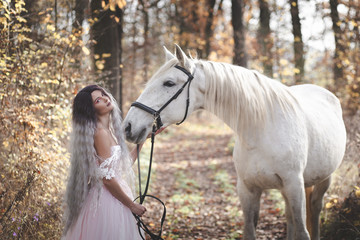 Beautiful girl with the white horse