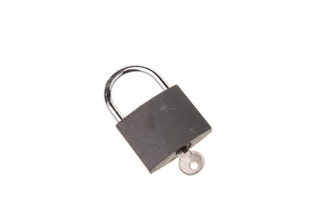 Closed gray padlock with key, isolated on white background