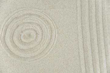 Obraz premium Abstract Zen drawing on white sand. Concept of harmony, balance and meditation, spa, massage, relax. Zen garden